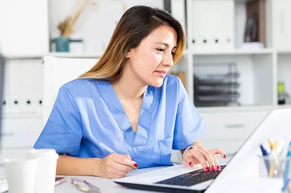 Nurse uses laptop