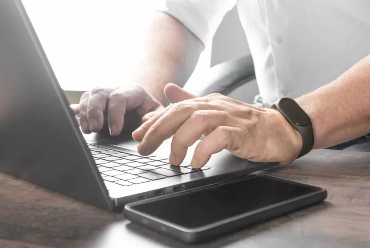 Man typing on a laptop